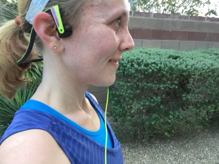 wearing the panasonic open-ear headphones