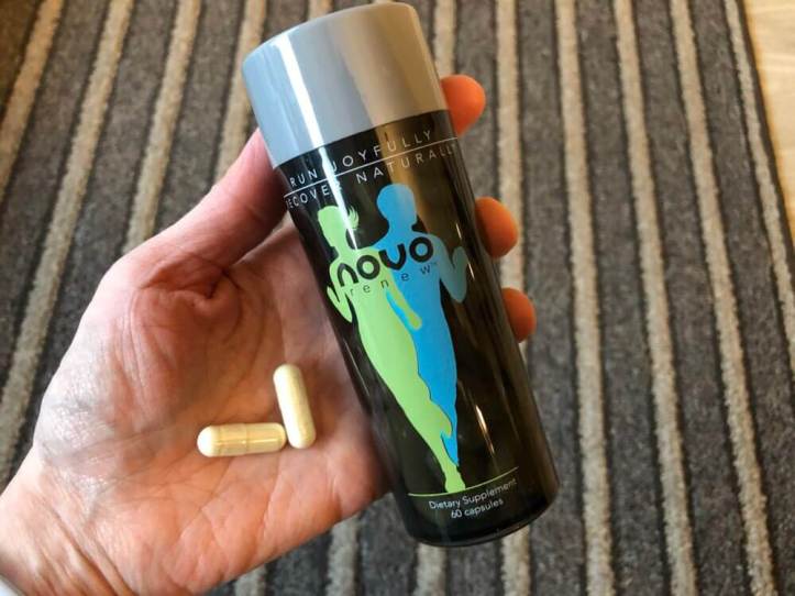 Bottle of Novo Renew and two pills in a hand