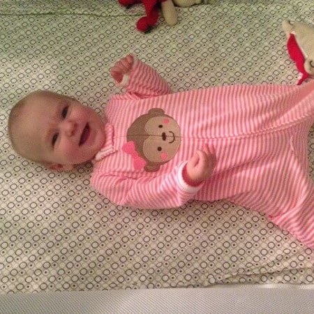 A day in my life - happy baby in her crib.