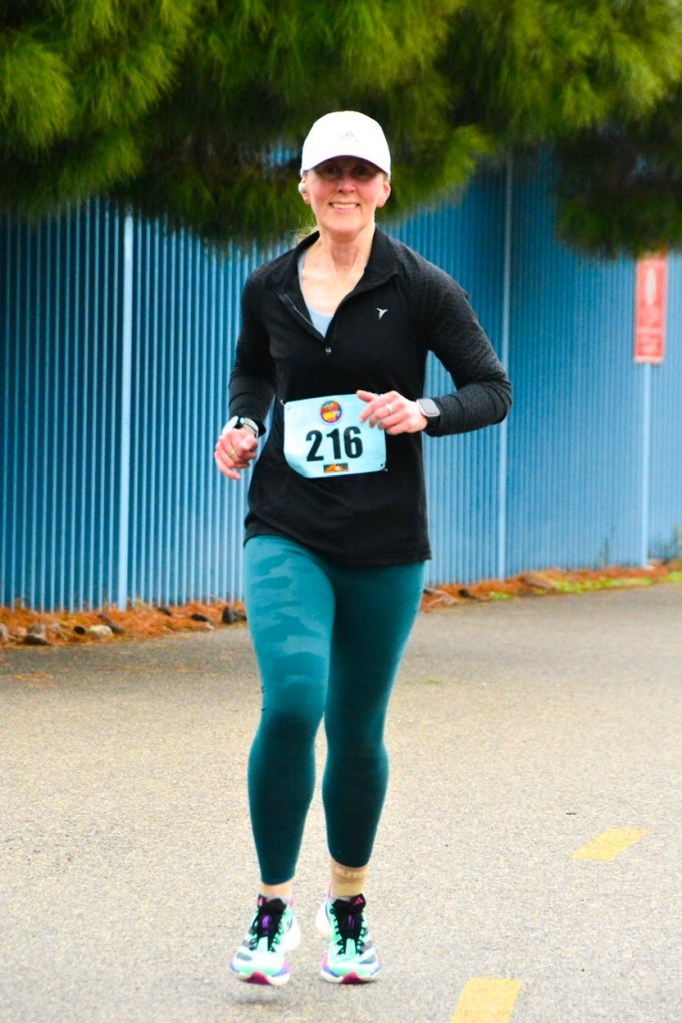 Mid-race photo of me running the Revolution Run 5K on 01/01/2026