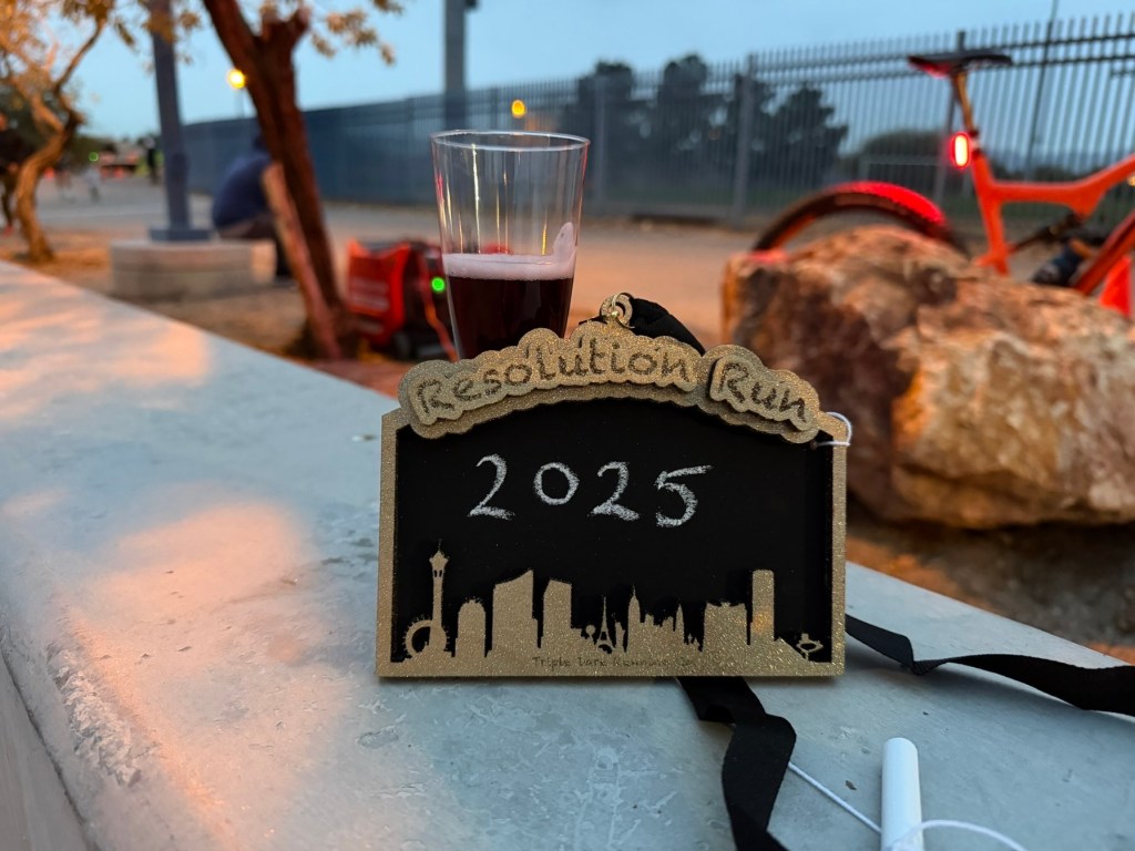 Medal and glass of fake champagne from the 2025 resolution run 5k